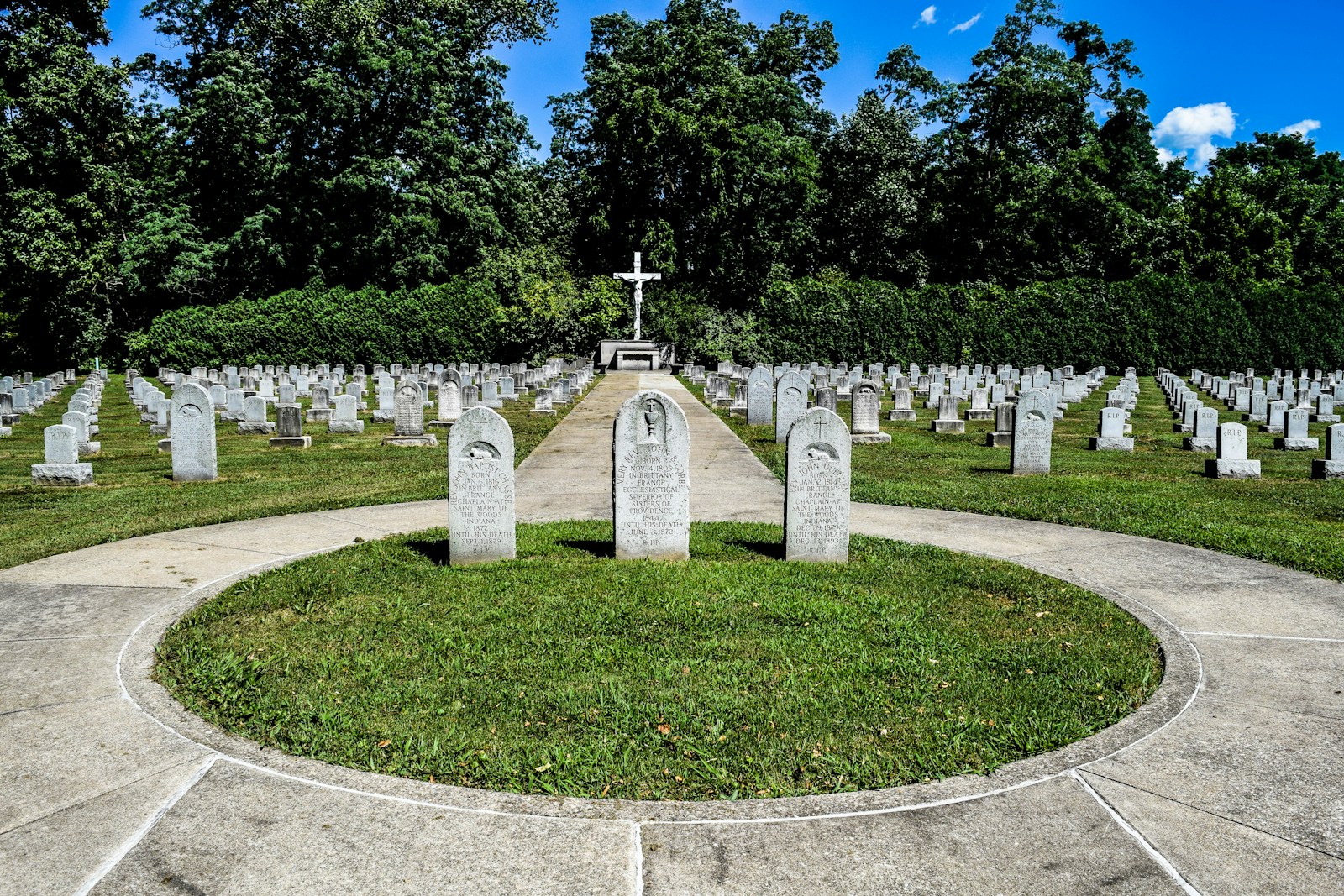 a cemetery with a cross in the middle of it