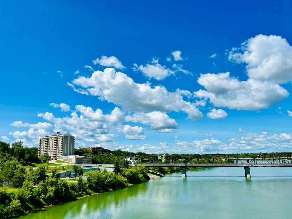 A body of water with a bridge in the background