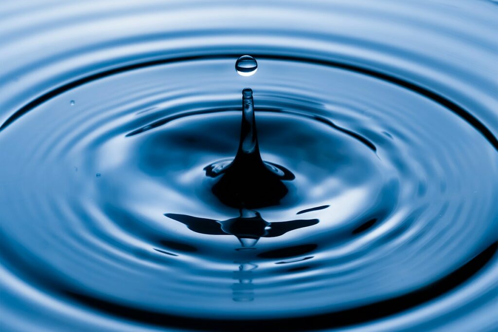 water drop in water in grayscale photography