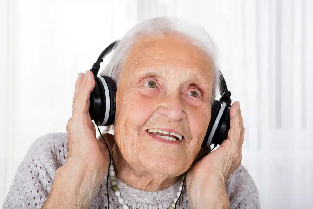 old woman with headphones listening to music