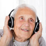 old woman with headphones listening to music