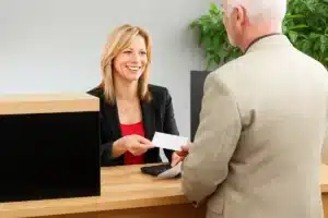 bank teller receives cheque